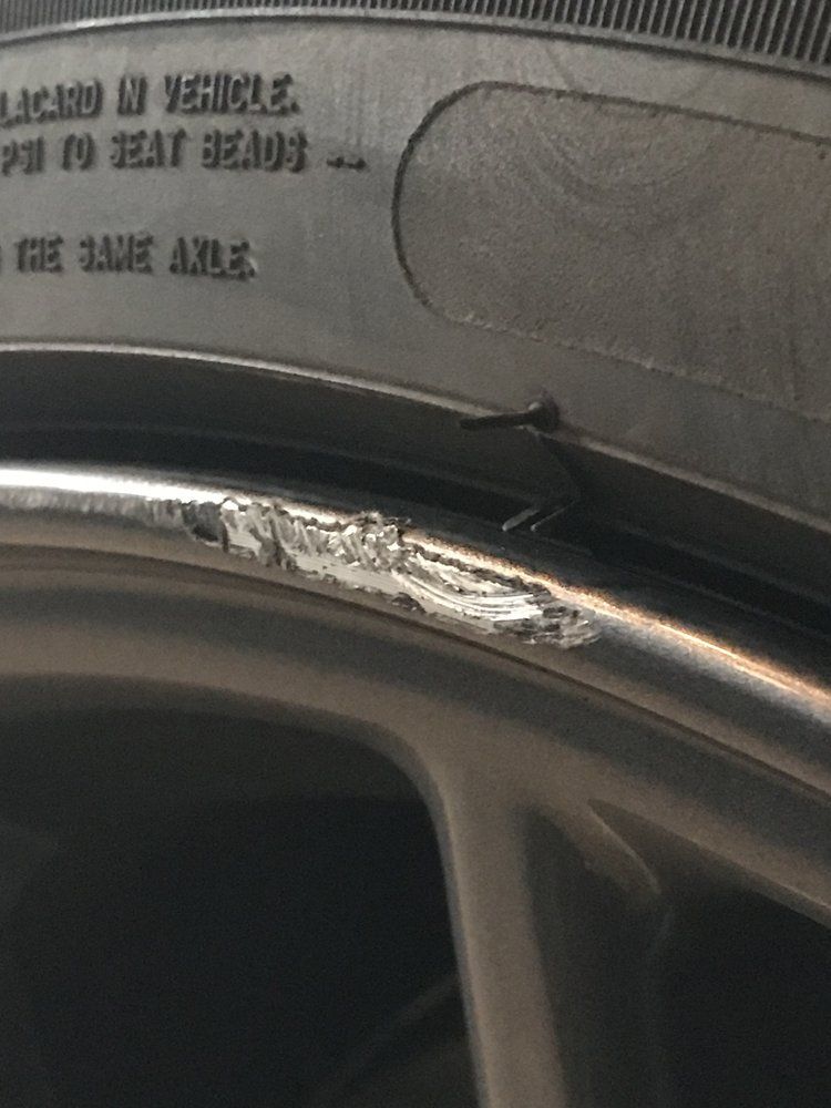 A close up of a tire with a damaged rim
