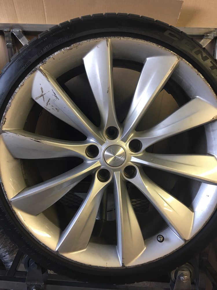 A close up of a tesla wheel and tire