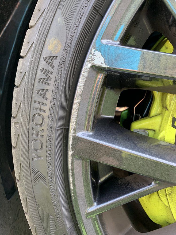 A close up of a yokohama tire on a car wheel.