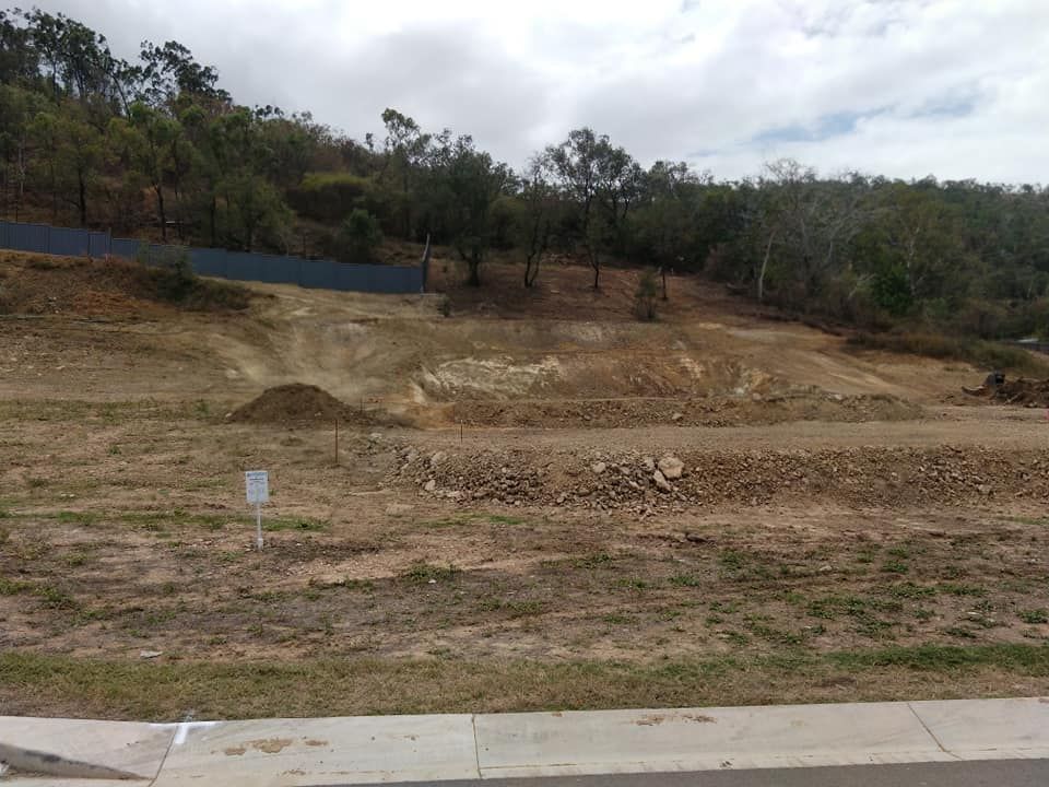 A Large Dirt Field With Trees In The Background — Allsites Earthworx In Garbutt, QLD