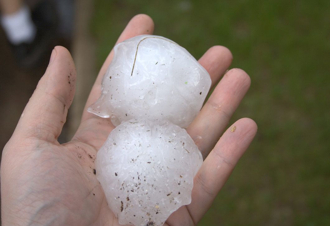 hand holding two hail stones