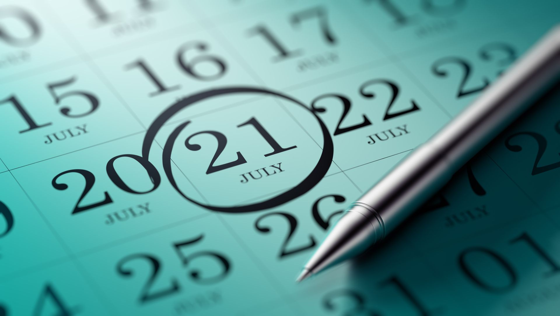 Calendar page with the 21st of July circled; a pen rests on the page.