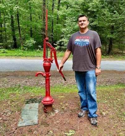 Man Holding A Red Water Pump — Nazareth, PA — Keystone Pump & Well Service