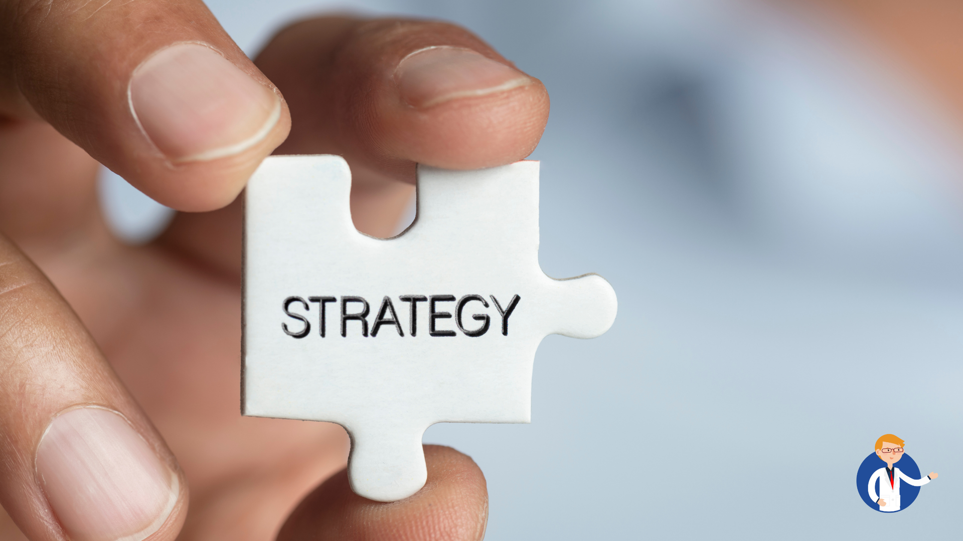 A person is holding a piece of puzzle with the word strategy written on it.