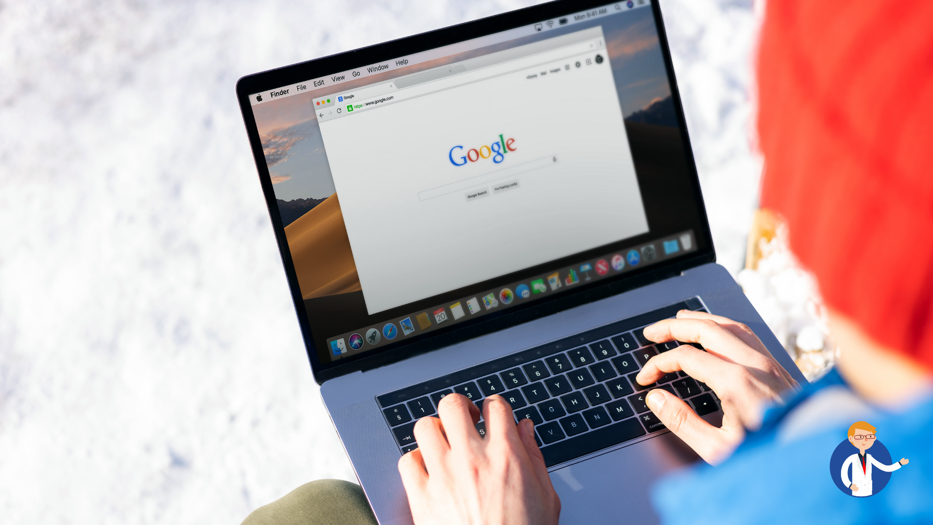 A person is typing on a laptop computer while sitting in the snow.