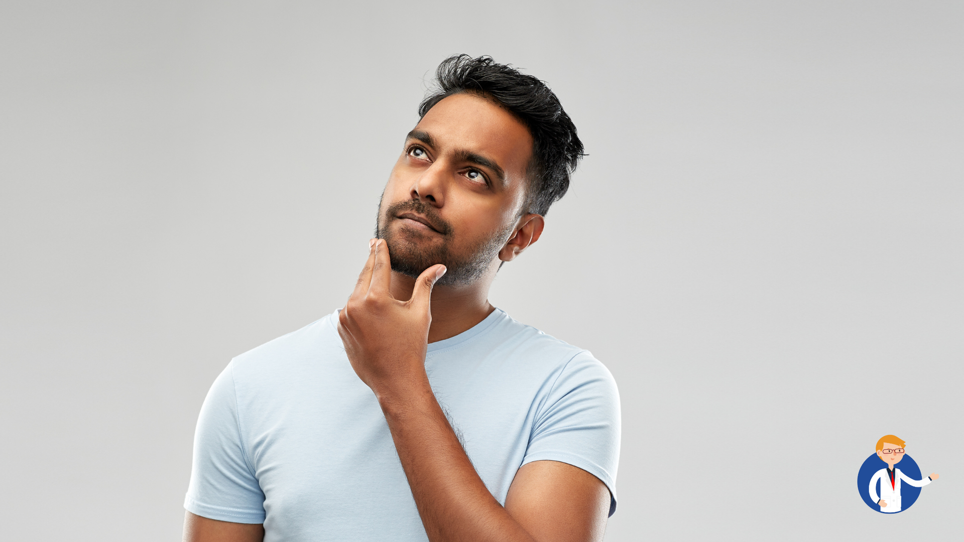 Man with dark hair and beard looking upward, hand on chin, thoughtful expression.