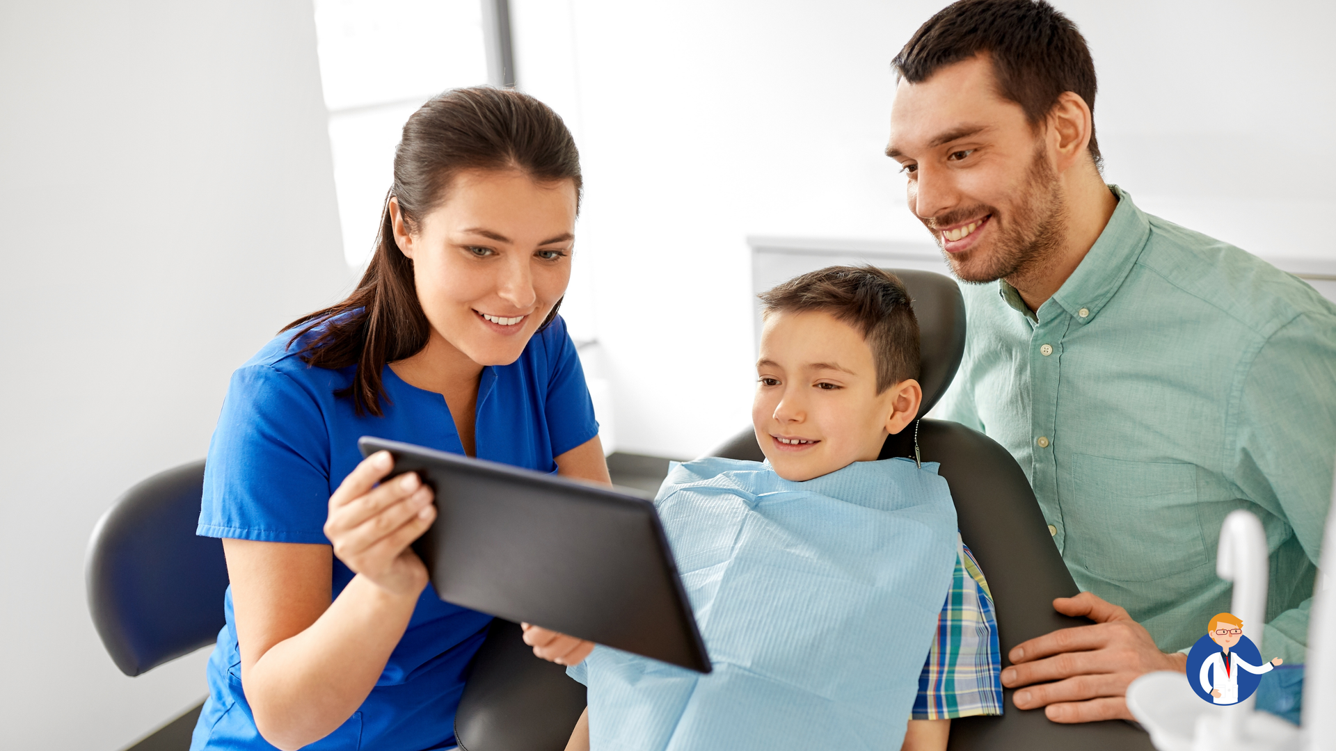 A family is sitting in a dental chair looking at a tablet.