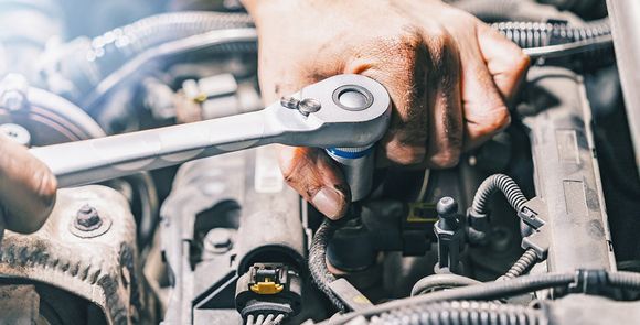Person Fixing Car Engine — Hermiston, OR — Pioneer Transmission Service Inc