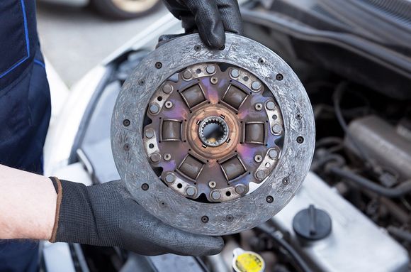 Person Holding Clutch Disc — Hermiston, OR — Pioneer Transmission Service Inc