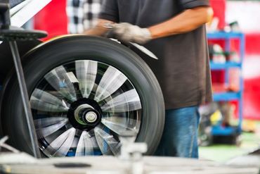 Inside a garage - balancing wheels-tires on spining wheel