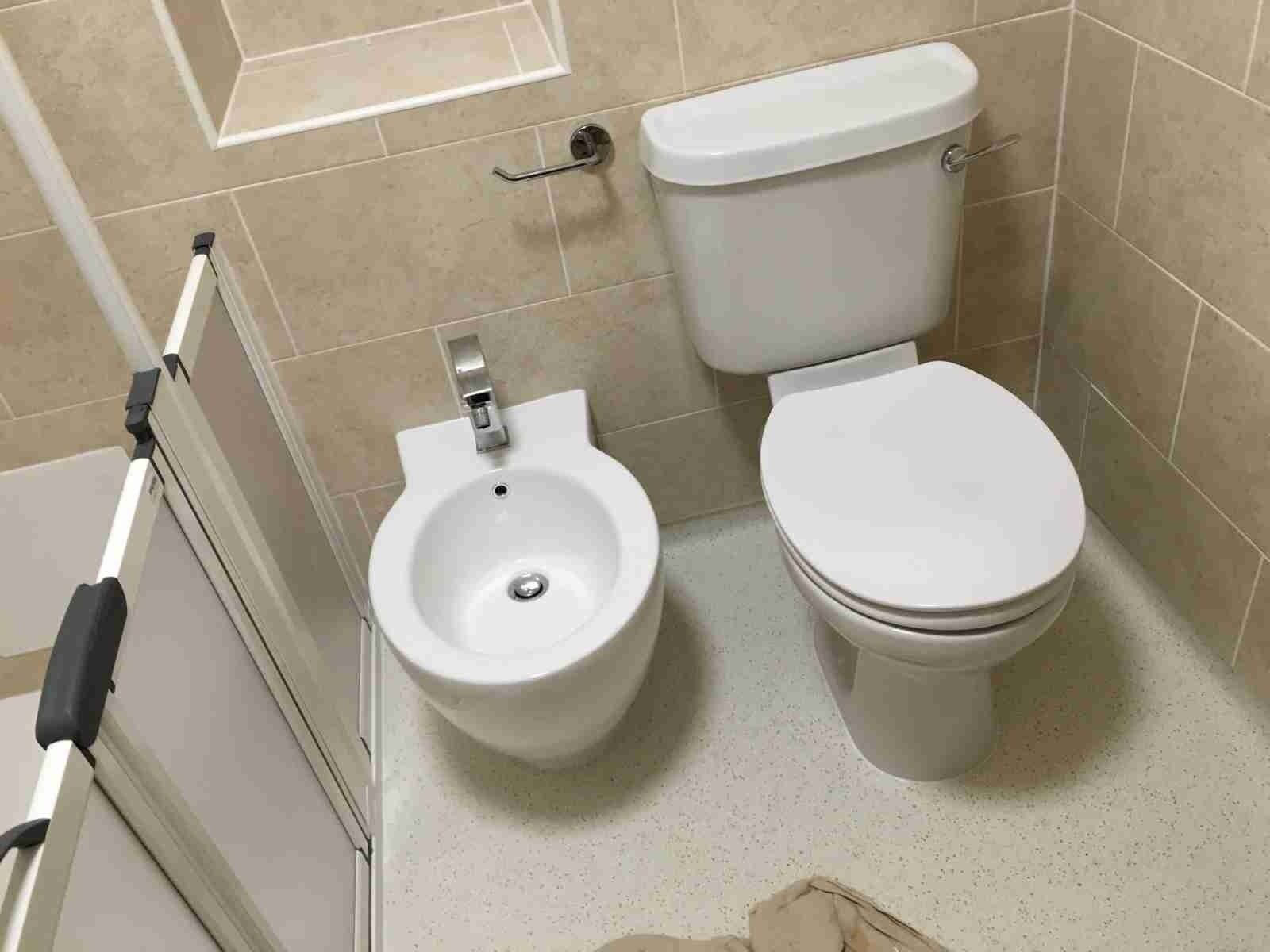 There is a bidet and toilet in the bathroom.