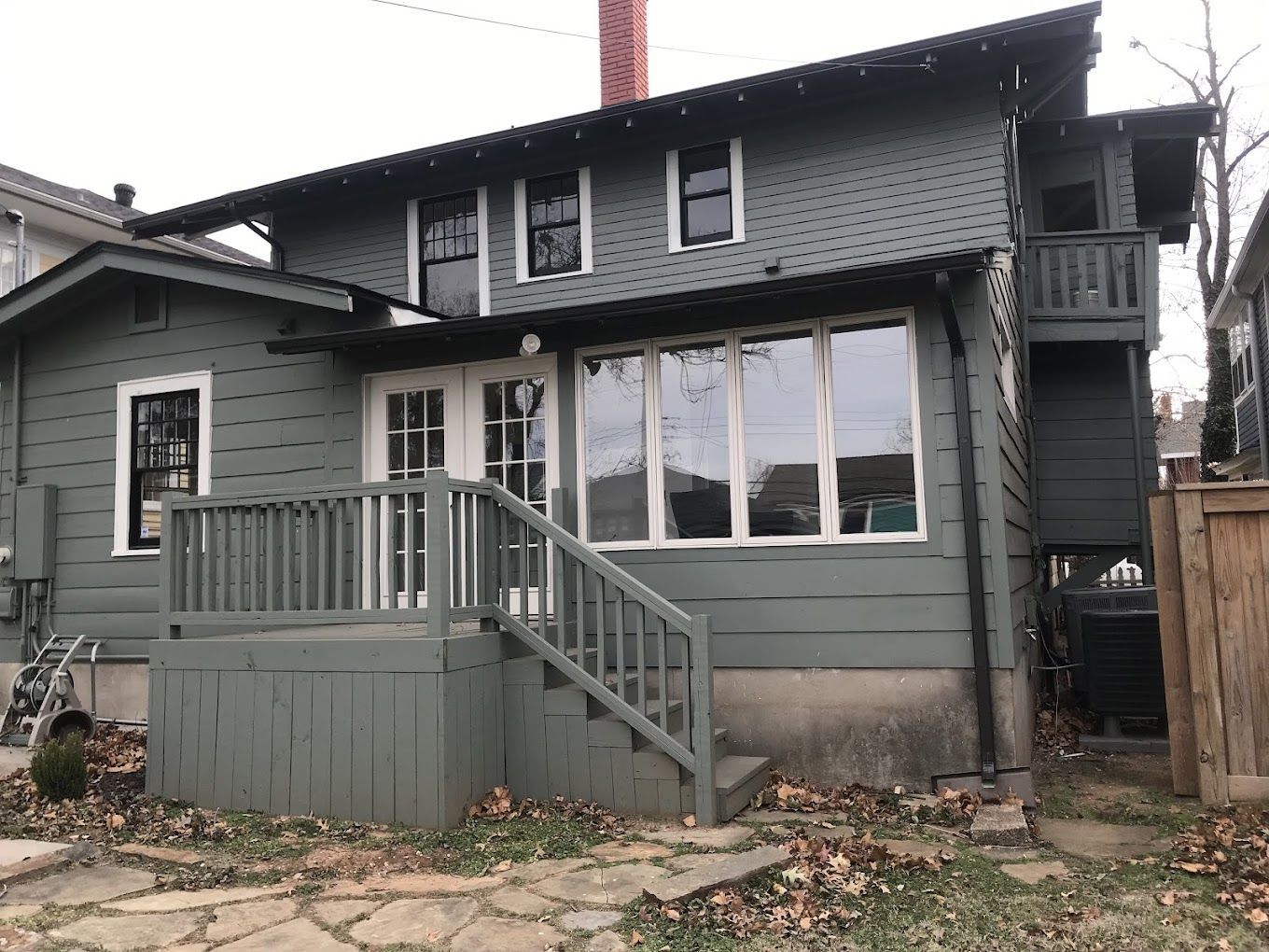 The back of a house with a deck and stairs.
