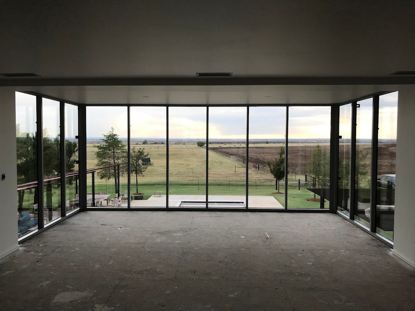A large room with a lot of windows and a view of a field.