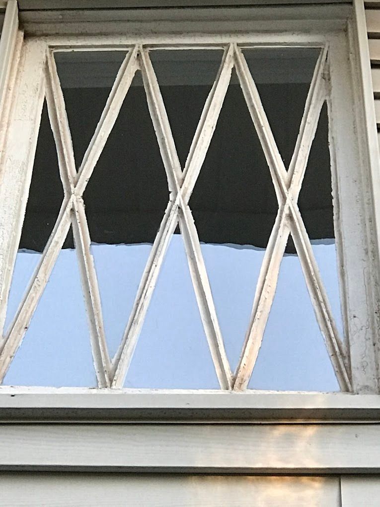 A close up of a window with a white frame