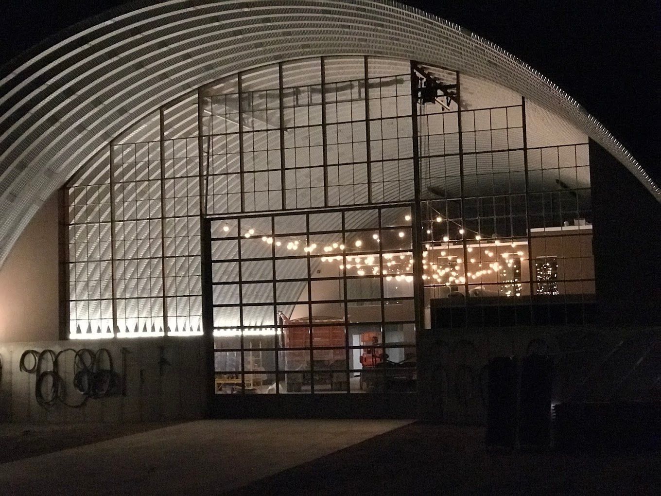A large building with a lot of windows is lit up at night