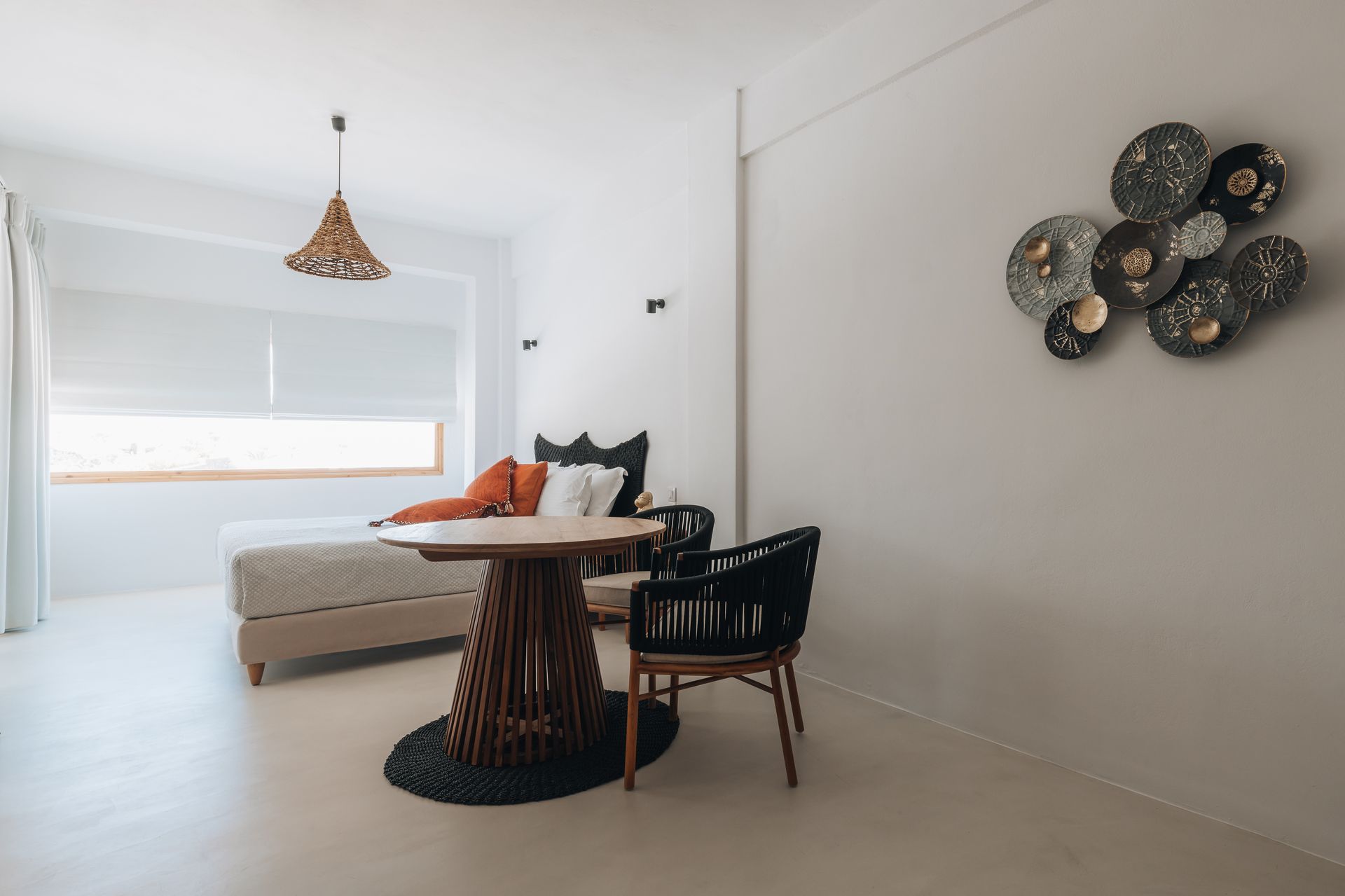 There is a table and chairs in the middle of the room.