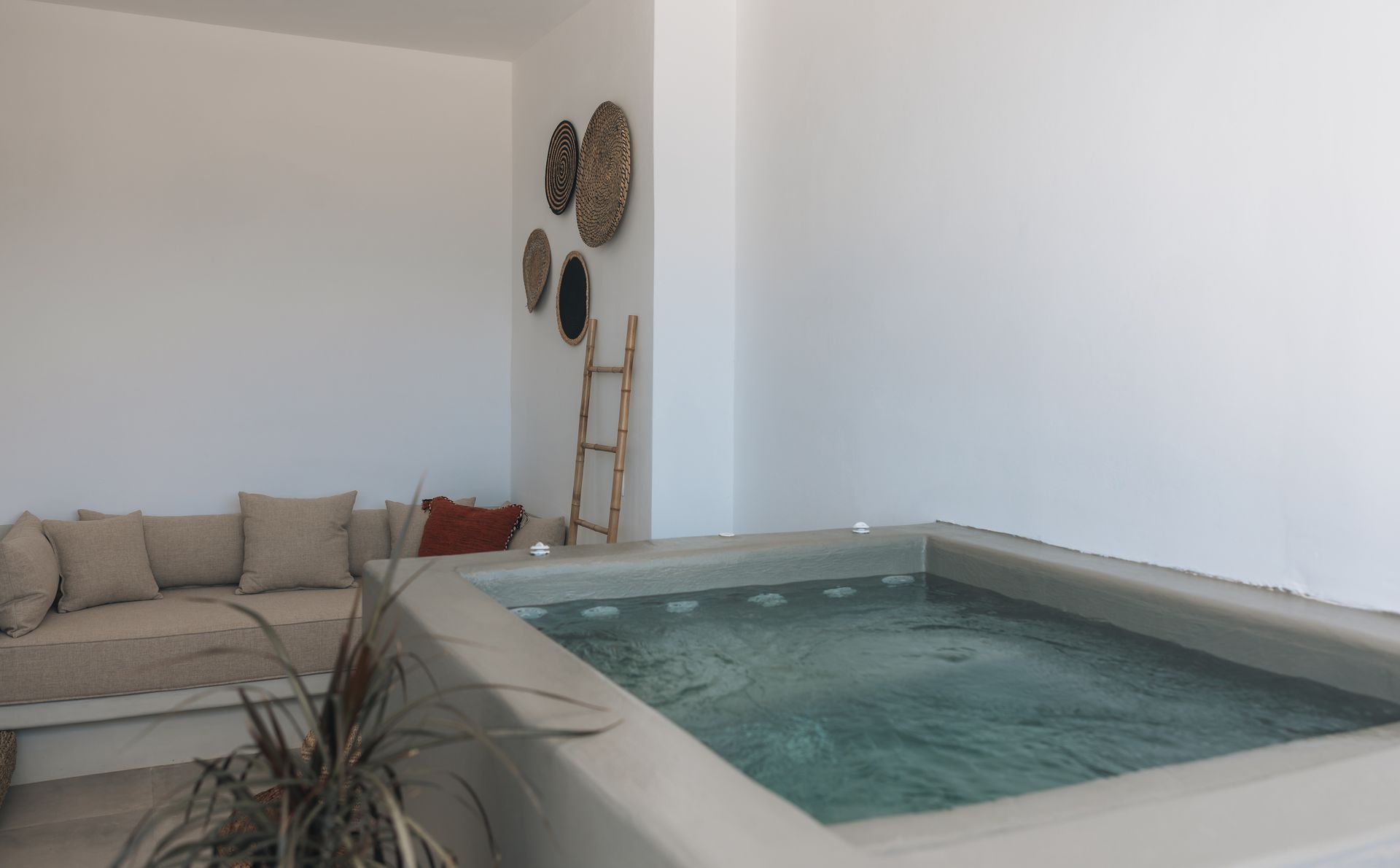 A living room with a couch and a hot tub.