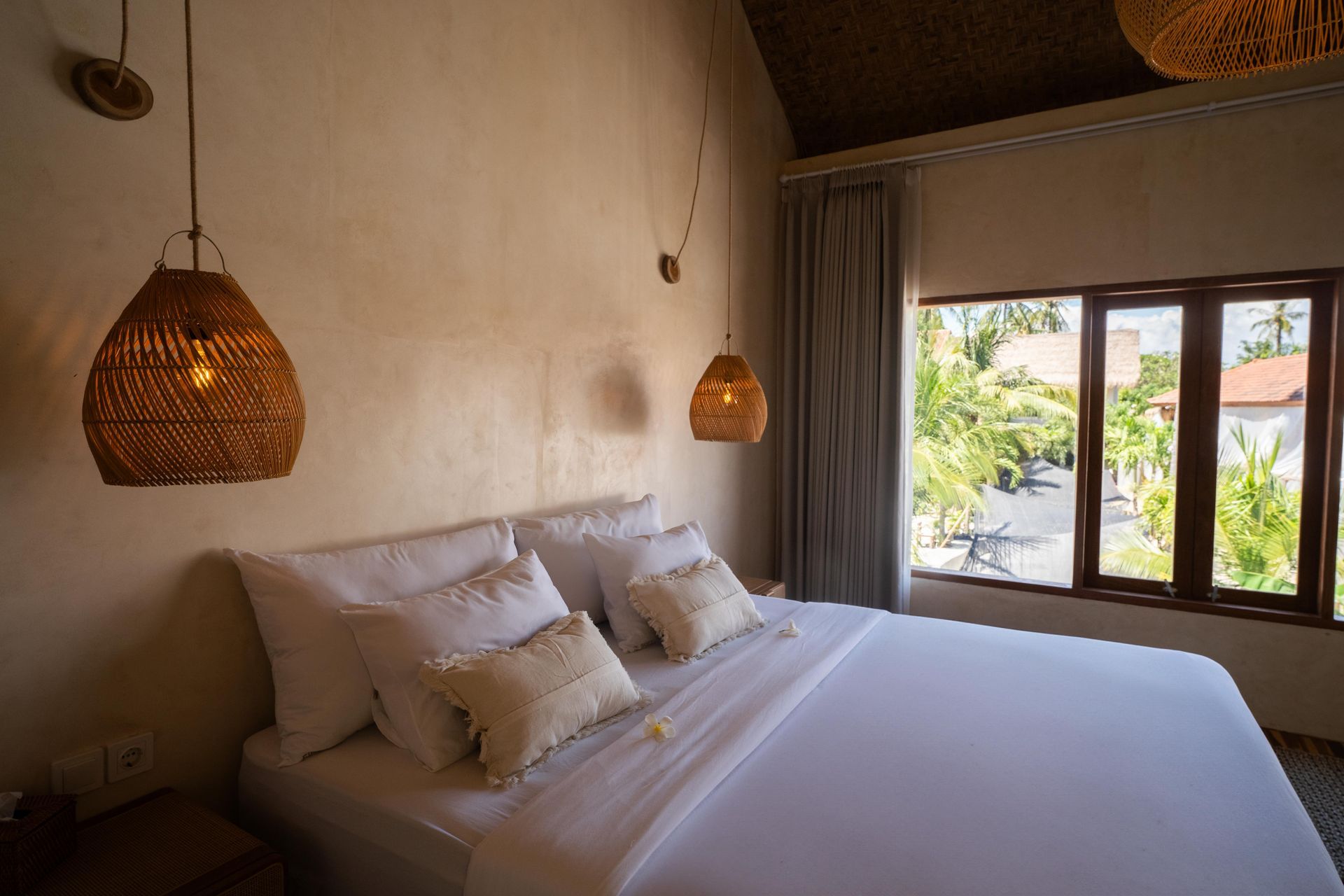 There is a bed in the middle of the room with a window.