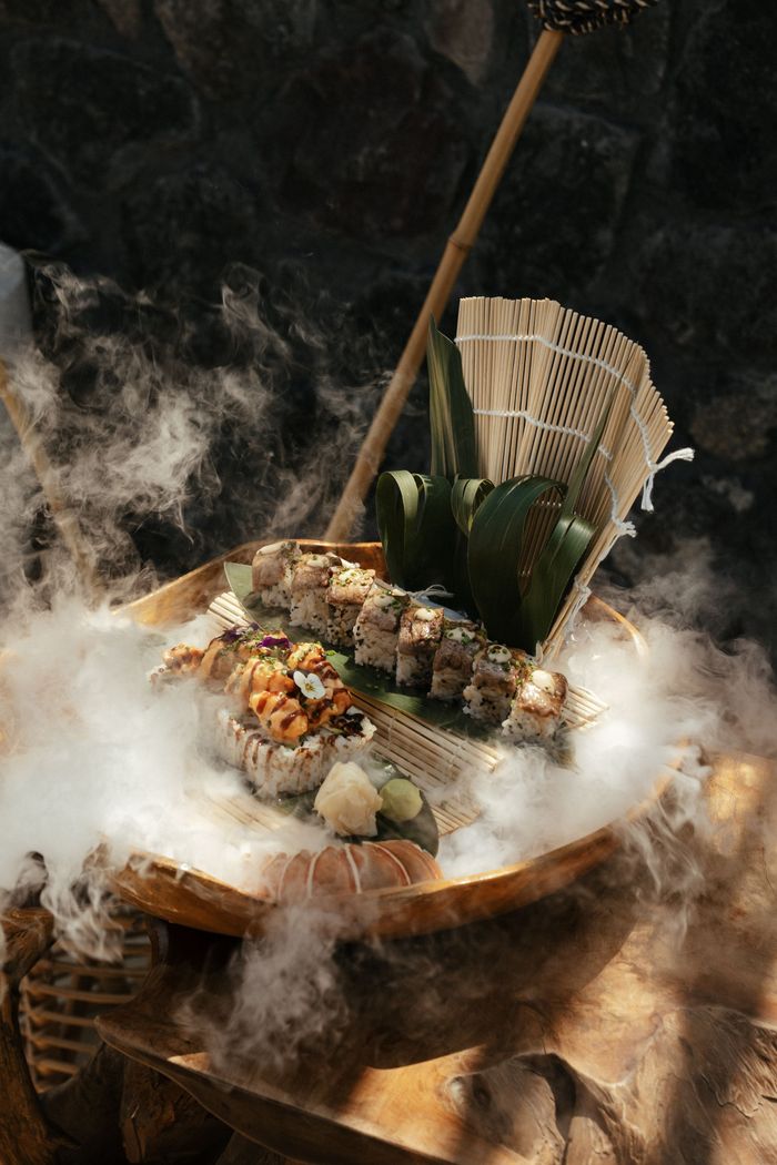 A bowl of food with smoke coming out of it on a table.