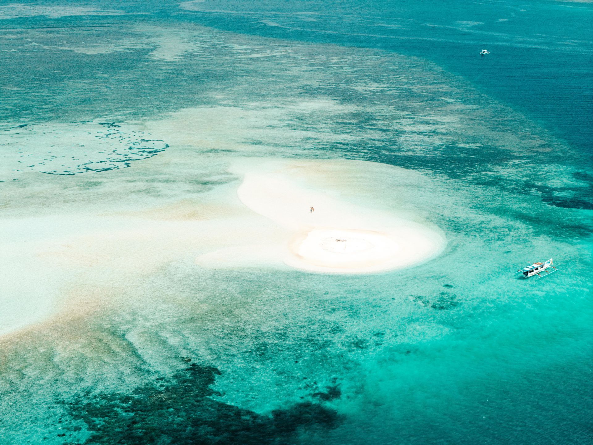 An aerial view of a small island in the middle of the ocean.