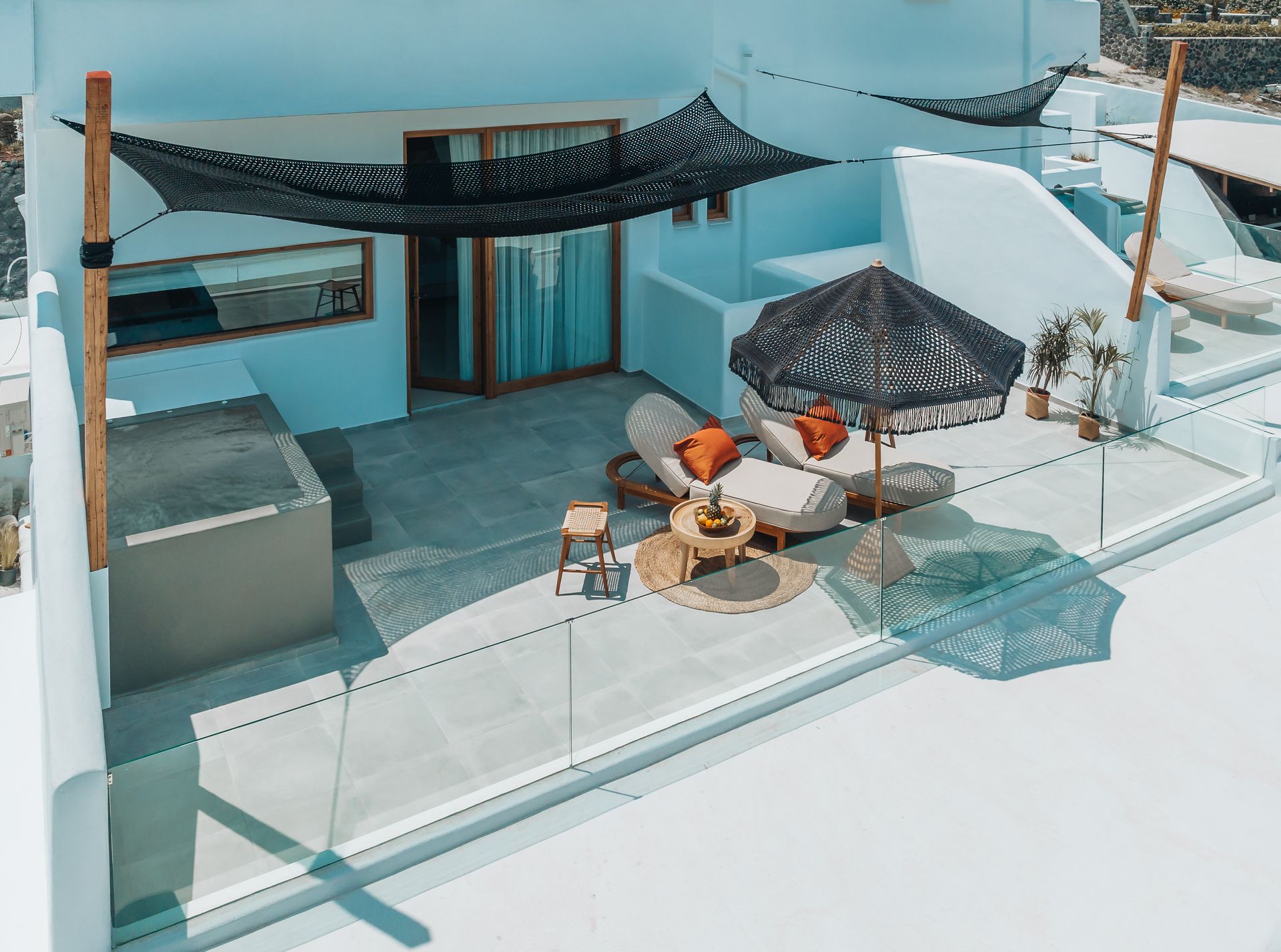An aerial view of a balcony with furniture and umbrellas.
