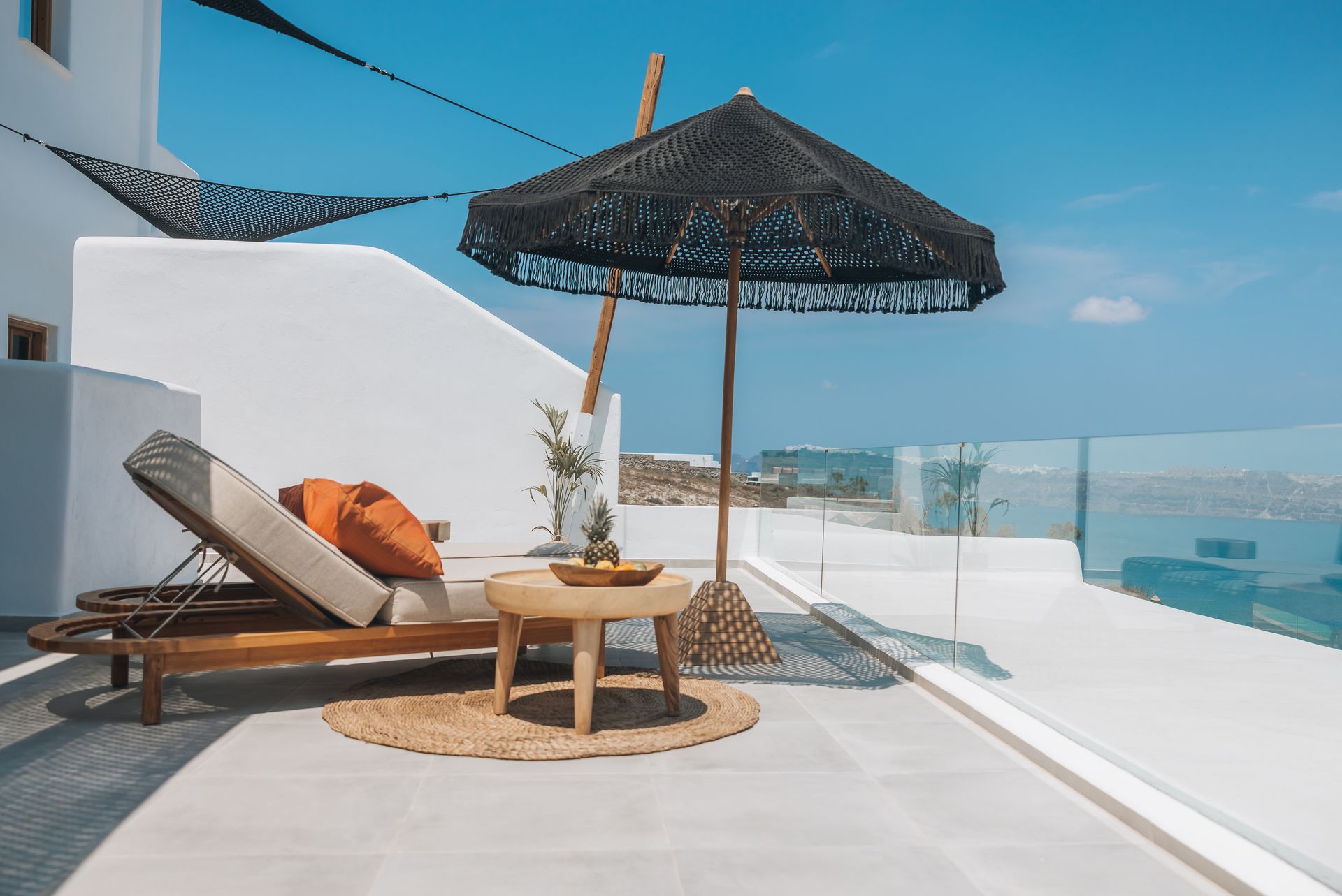 There is an umbrella and a table on the balcony.