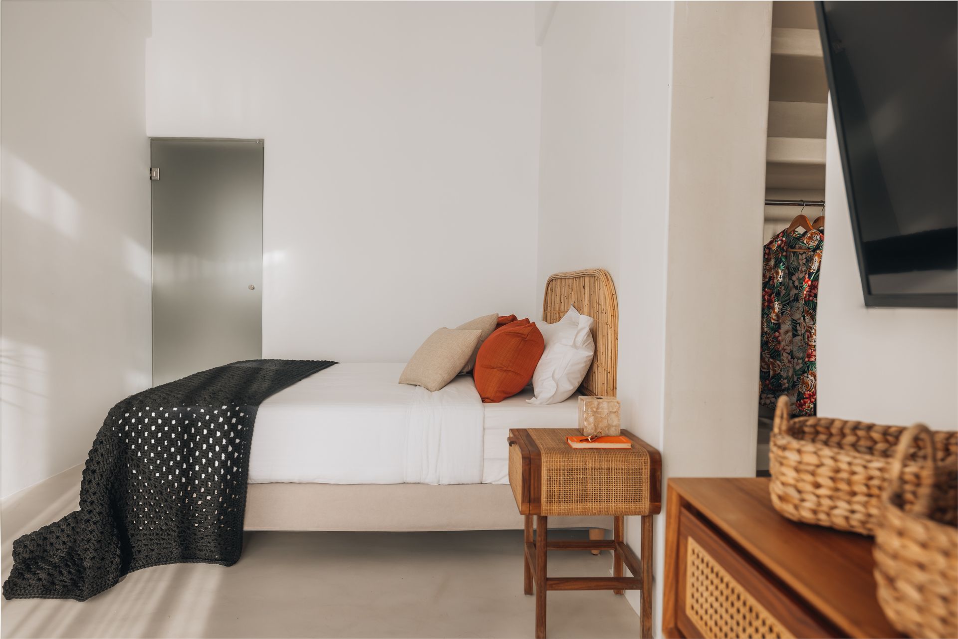 A bedroom with a bed , nightstand , and television.