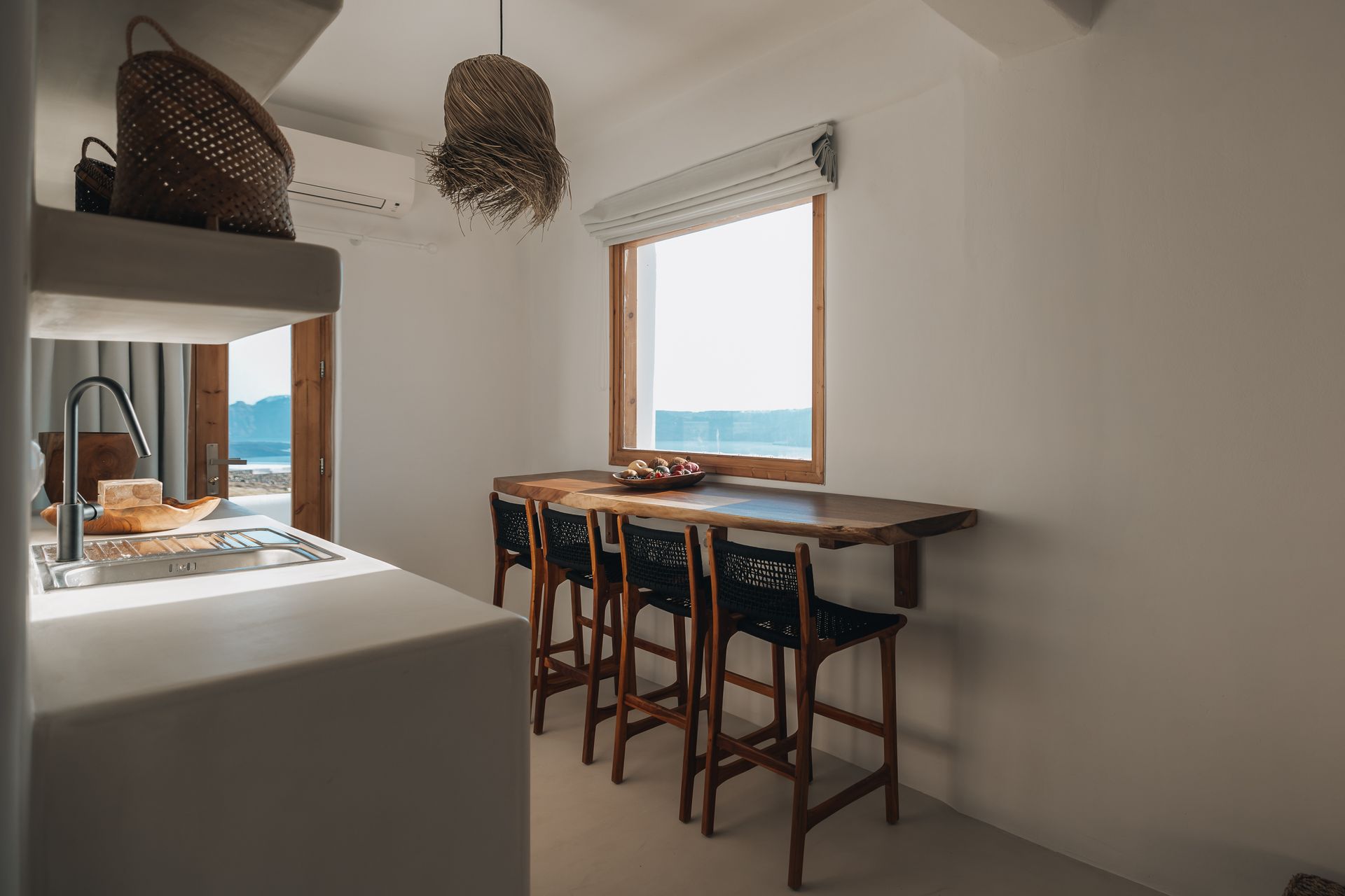 A kitchen with a table and chairs and a window.