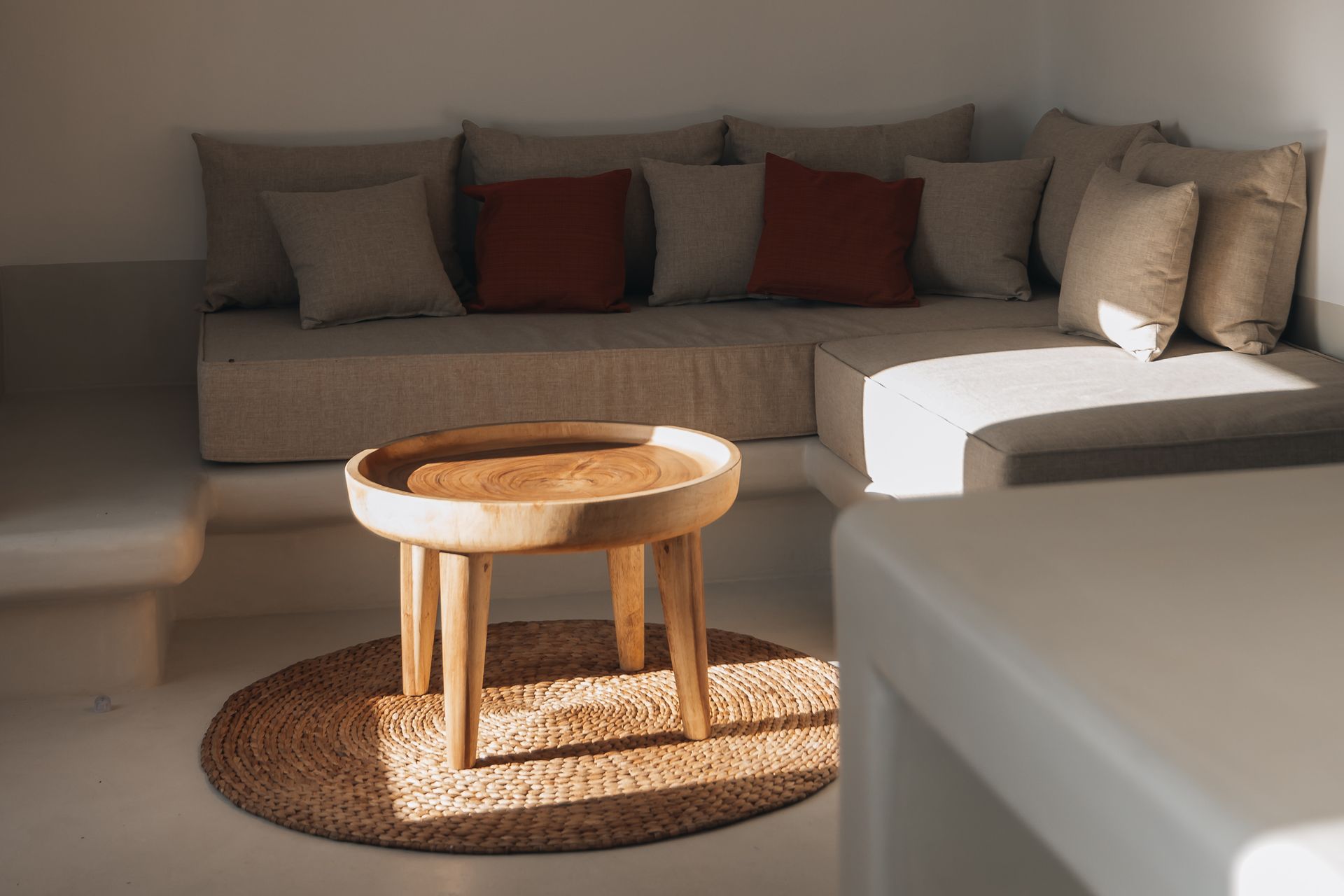 A living room with a couch , table , and rug.