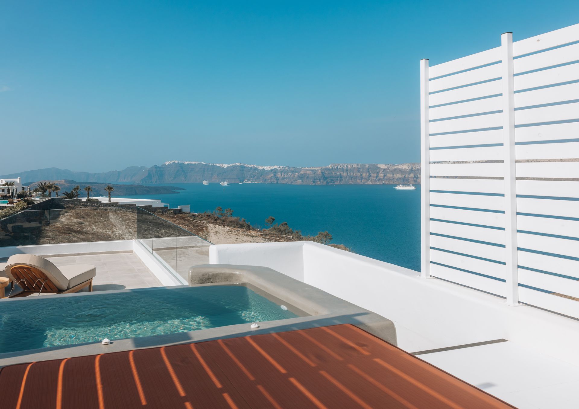 There is a swimming pool with a view of the ocean.
