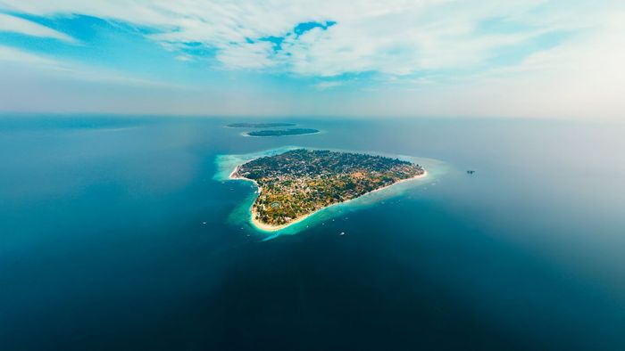 An aerial view of a small island in the middle of the ocean.