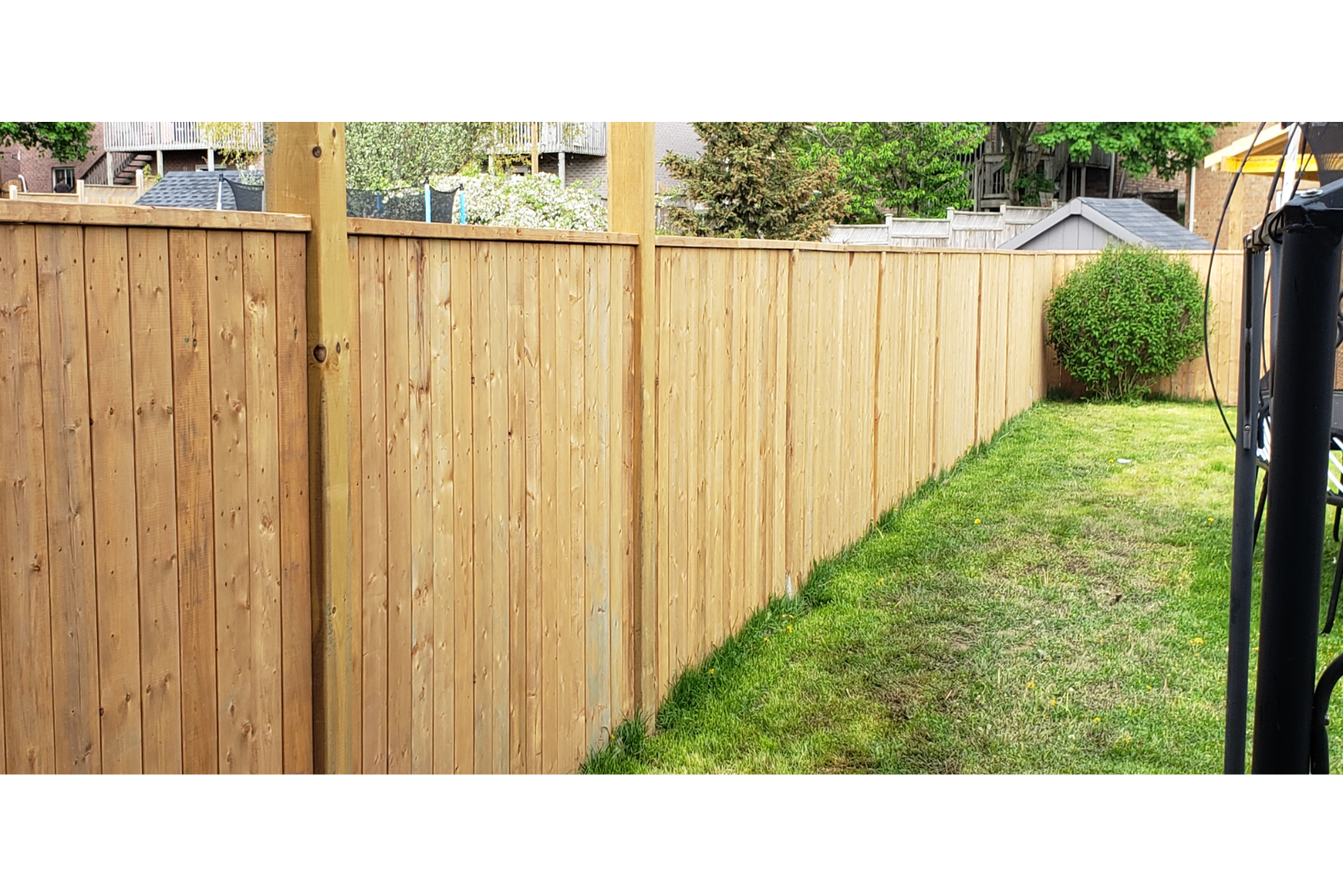 An image of a wood privacy fence separating yards in Kent, OH