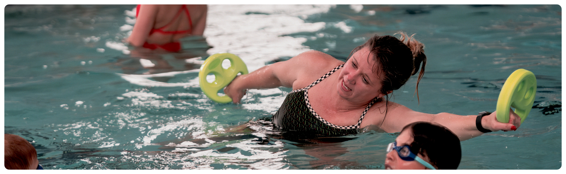 woman in pool performing exercises