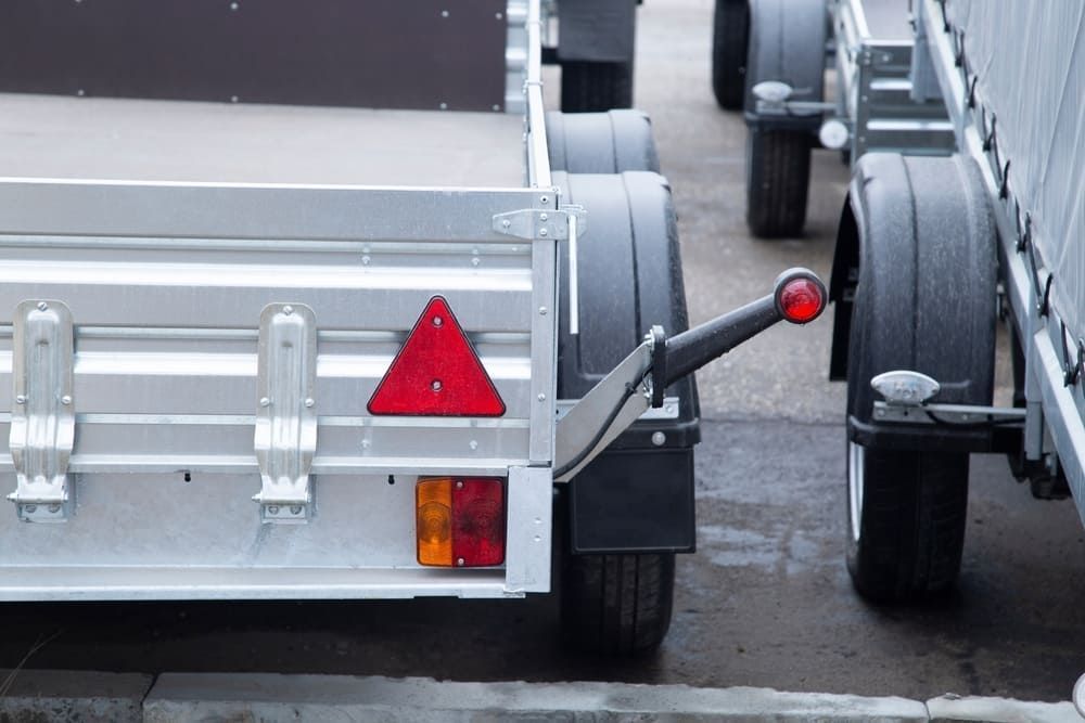 A Row Of Trailers Are Parked Next To Each Other On The Side Of The Road — Wilson's Towing In Esk, QLD