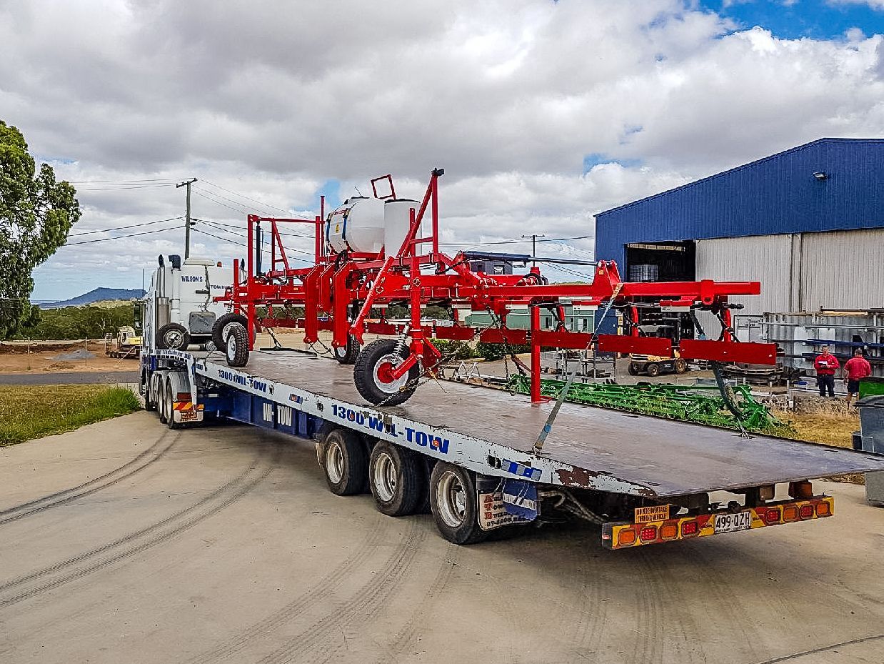 A Tow Truck Pulling Agriculture Equipment — Wilson's Towing In North Toowoomba, QLD