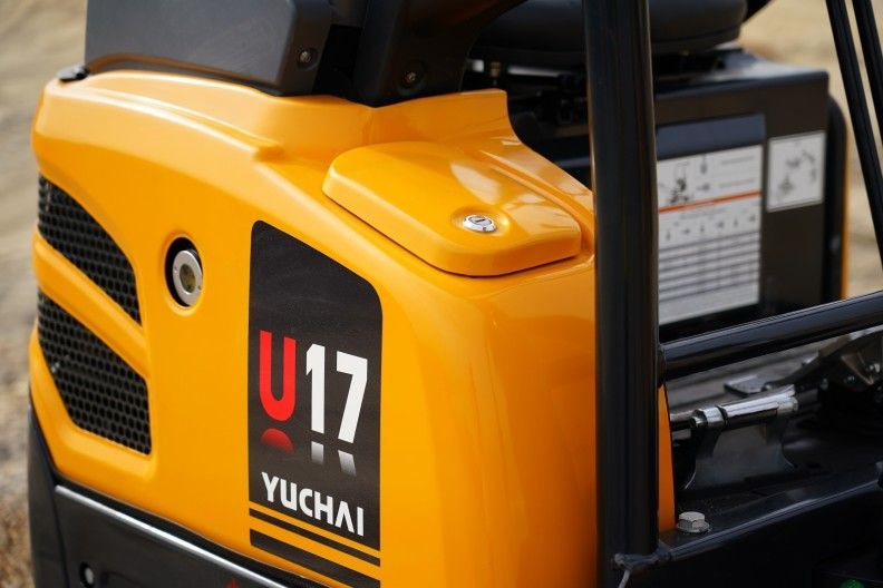 Yellow Yuchai U17 mini excavator detail; orange machine body, black grill, and printed text.