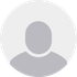A gray circle with a silhouette of a person in it.