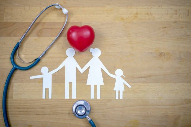 Family cutout with a red heart, stethoscope, suggesting health insurance or care.