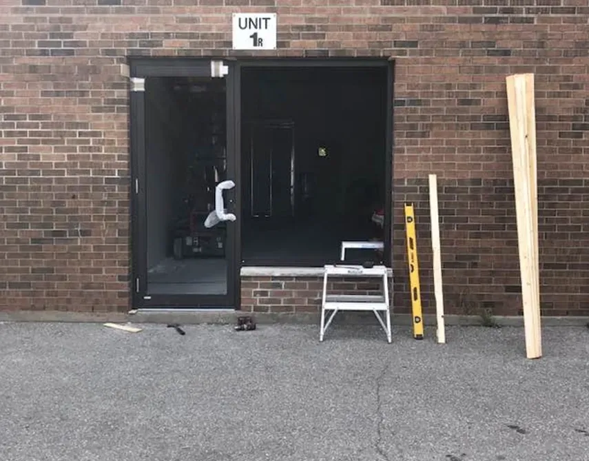 A brick building with a sign that says unit 1