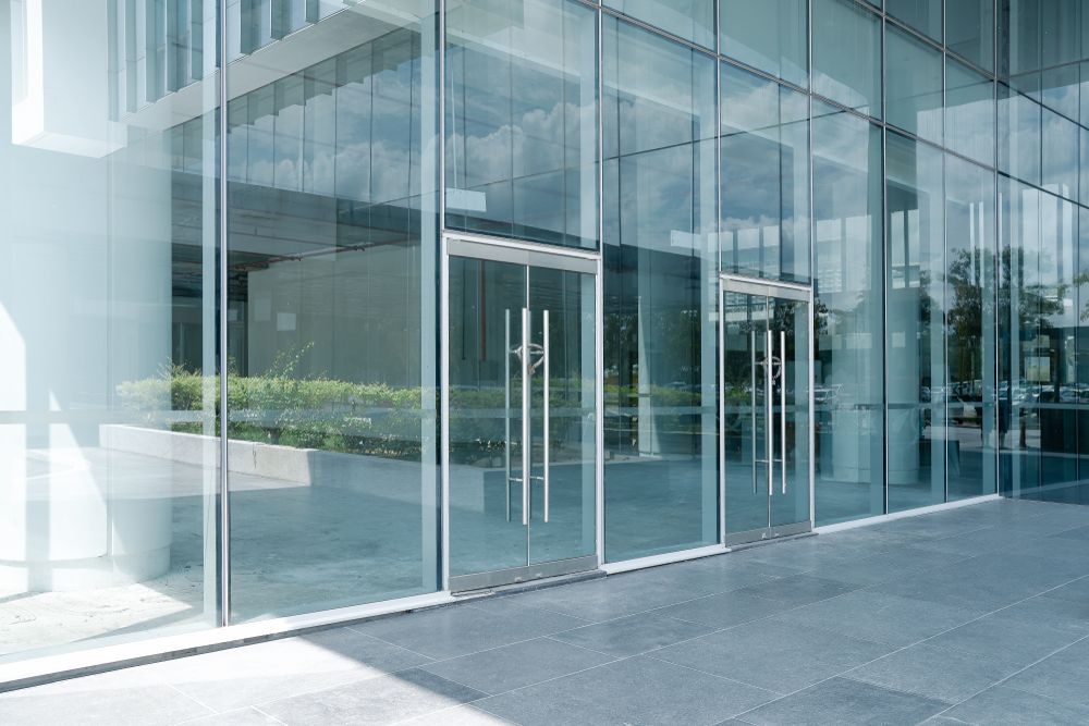 A large glass building with a lot of windows and doors.