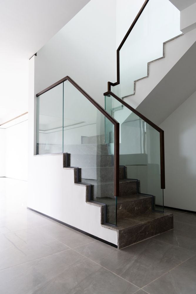 A staircase with a glass railing in a house