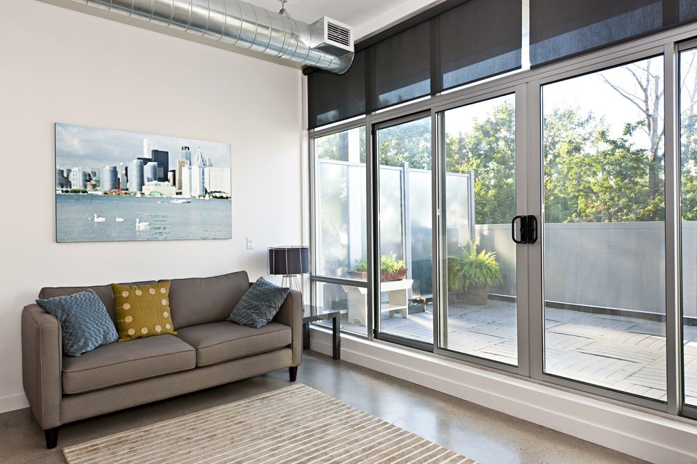 A living room with a couch and a large window
