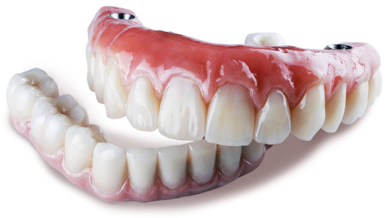 A close up of a denture on a white background