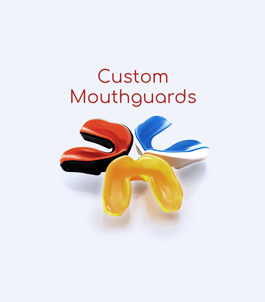 Three mouthguards are sitting on top of each other on a white surface.