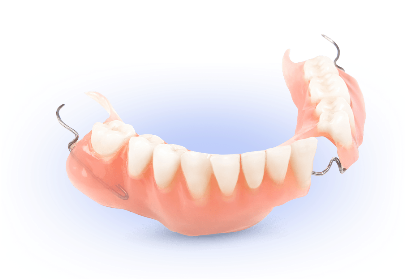 A close up of a denture on a blue surface.