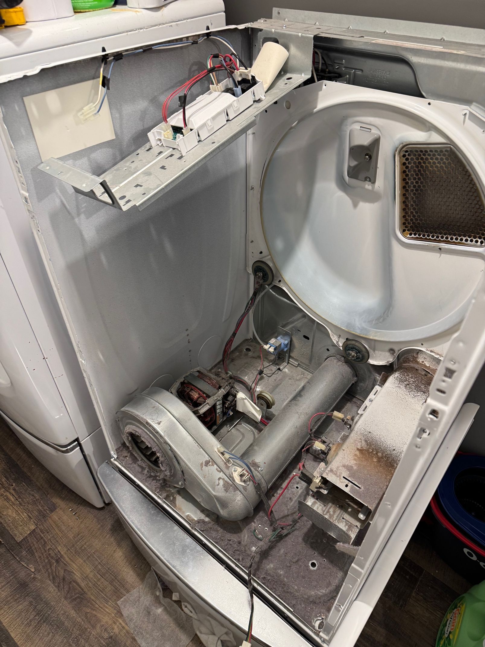 A bathroom with a washer and dryer and a sink