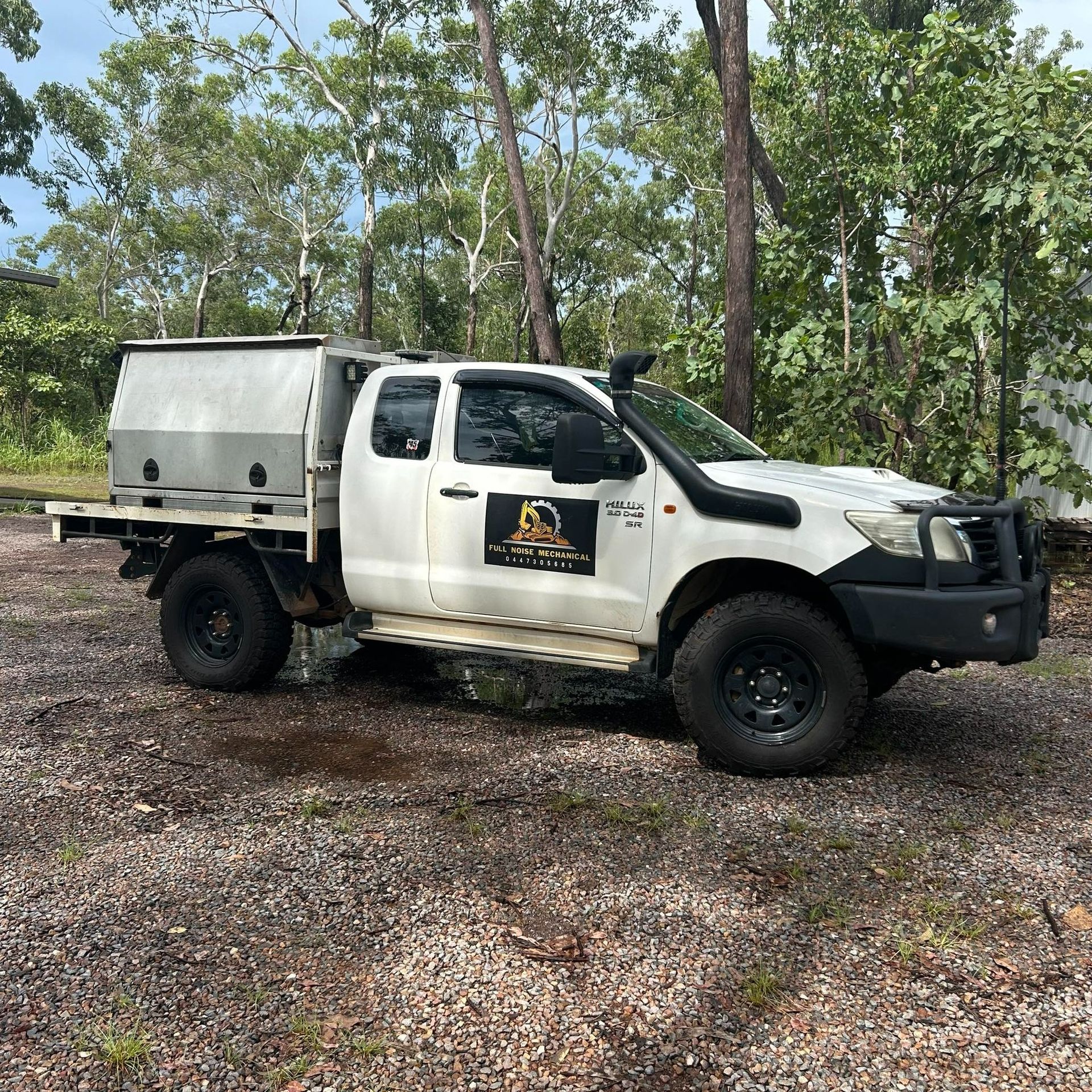 White Toyota pickup truck with a utility bed, in a forest setting — Full Noise Mechanical in Humpty Doo, NT