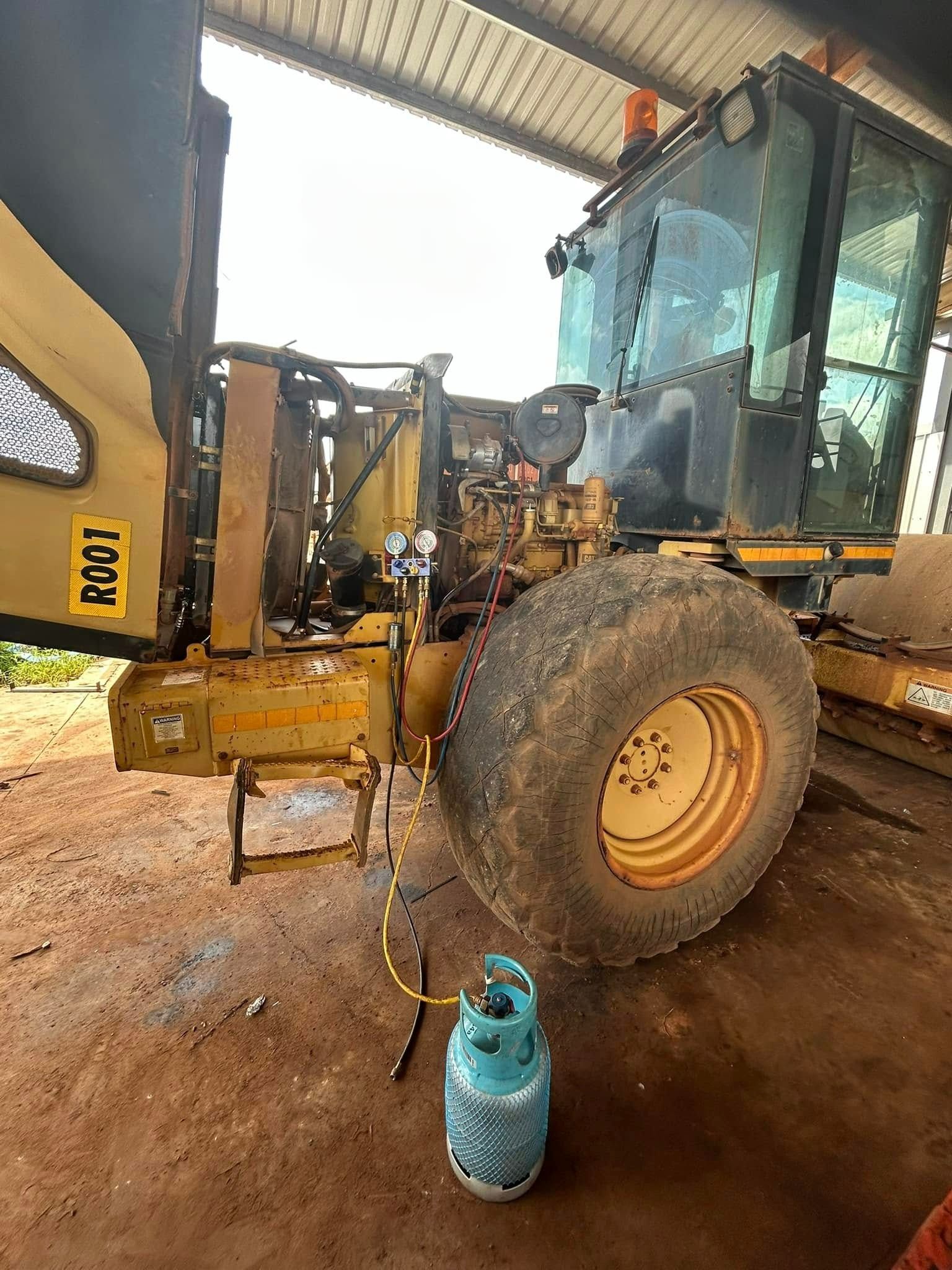 Yellow heavy machinery with a large wheel, a cab, and a blue gas cylinder — Full Noise Mechanical in Humpty Doo, NT