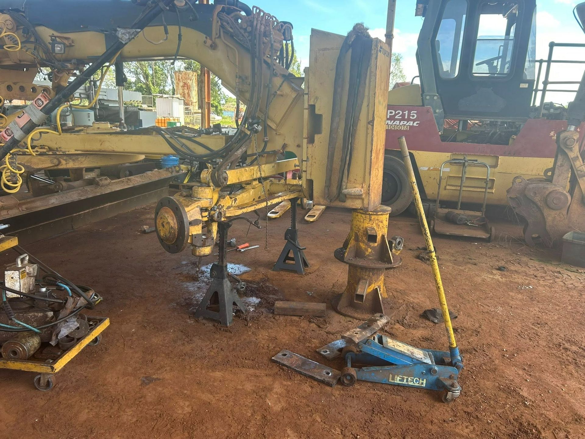 Heavy Machinery Being Repaired Supported by Jacks in a Red Dirt Area — Full Noise Mechanical in Humpty Doo, NT