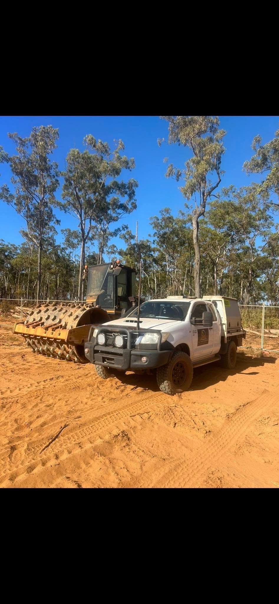 White truck and bulldozer in a sandy, tree-lined area under a clear, blue sky — Full Noise Mechanical in Humpty Doo, NT